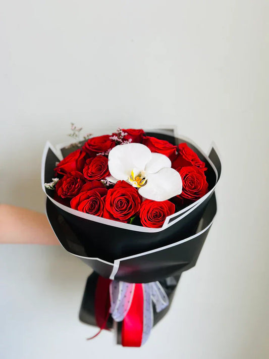 girl holding the flowers like orchids and roses in a bouquet