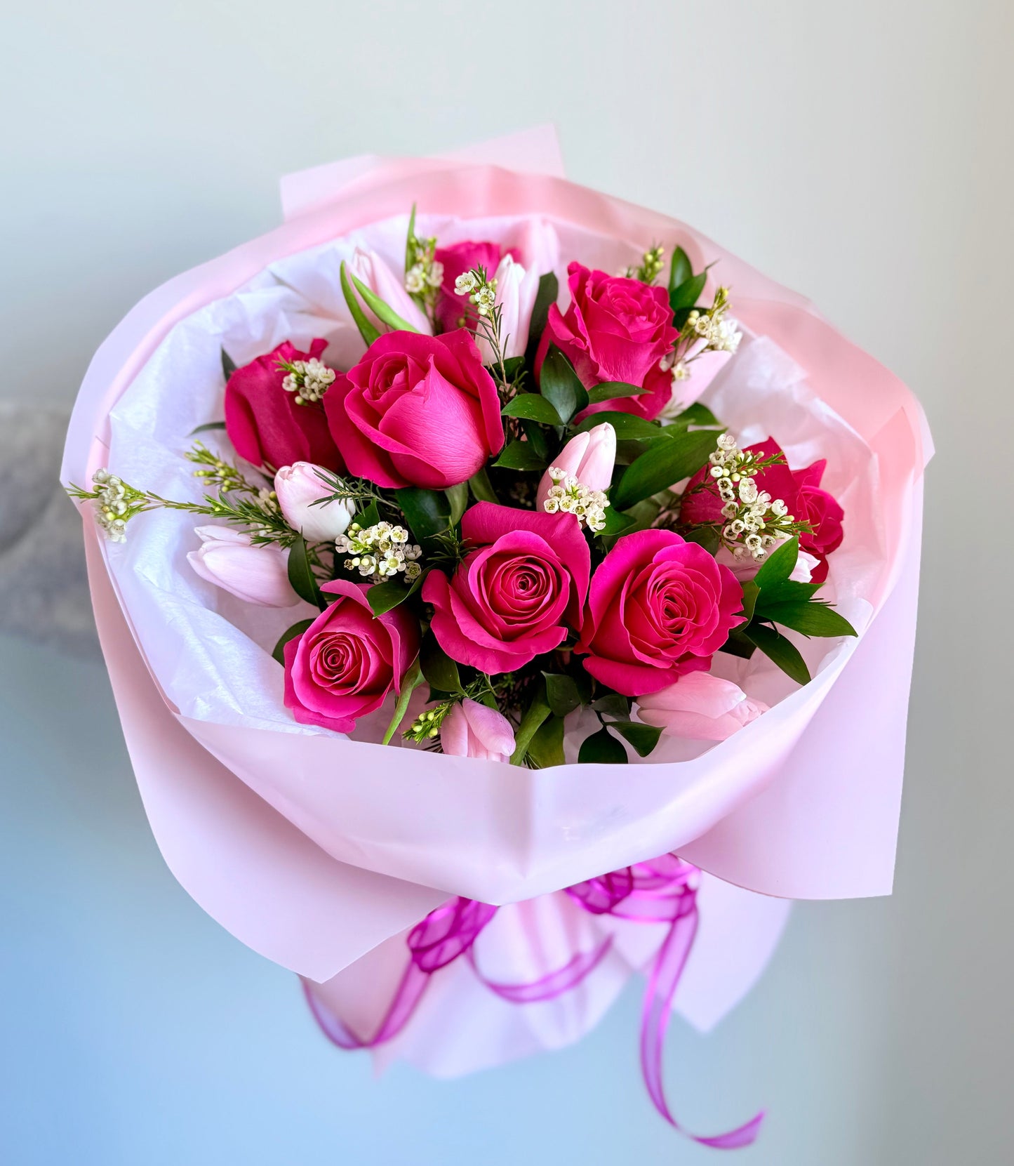 A bouquet of pink roses and tulips