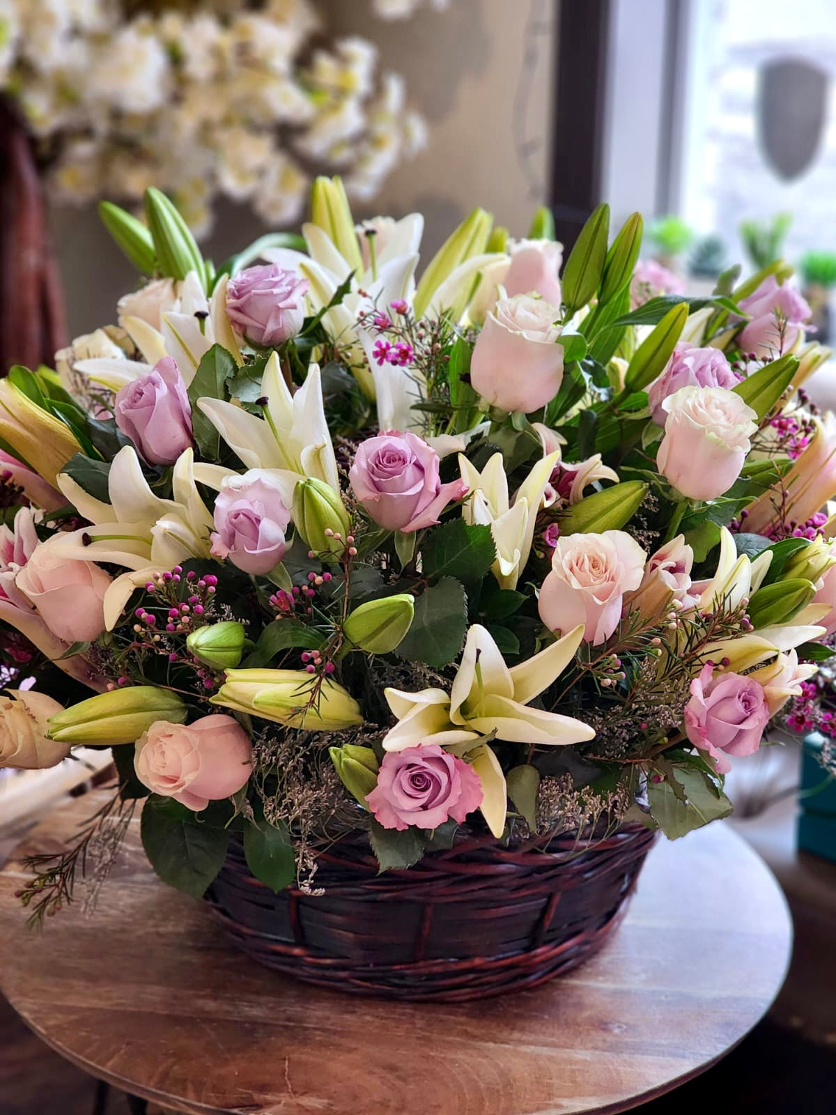 pink lily purple roses baseket