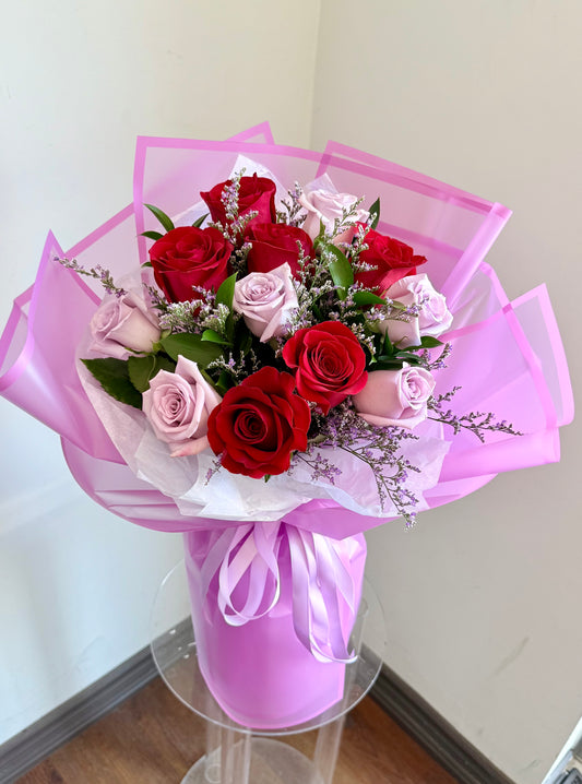 Bouquet of red and purple roses with elegant wrapping